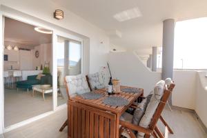a kitchen and living room with a table and chairs at Apt w Beach/Mountain Views, Pool and Parking in Tarifa
