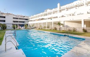 a swimming pool in front of a building at Apt w Beach/Mountain Views, Pool and Parking in Tarifa