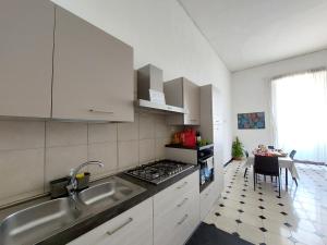 a kitchen with a sink and a stove top oven at Casa Cenzina in Cosenza