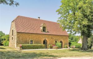 a large brick church with a red roof at Stunning Home In Valojoulx With Outdoor Swimming Pool in Valojoulx