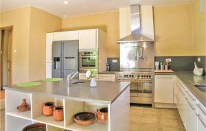 a large kitchen with a stainless steel refrigerator at Awesome Home In Valojoulx With 2 Bedrooms, Wifi And Outdoor Swimming Pool in Valojoulx