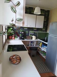 a kitchen with a bowl of food on a counter at Chambre privée dans chalet au calme in Saint-Brisson