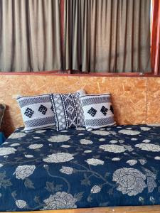 a bed with two pillows on top of it at Succah in the Desert in Mitzpe Ramon