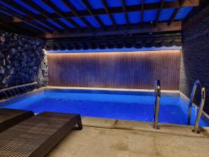 a swimming pool in a room with a stone wall at Yeonriji in Gyeongju