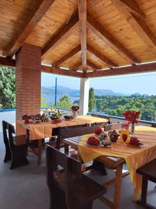 a dining room with wooden tables and a large window at Villa Sea Dream Koločep in Koločep