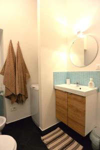 La salle de bains est pourvue d'un lavabo, de toilettes et d'un miroir. dans l'établissement Appartamento dei Sassetti, à Savone