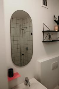 a bathroom with a mirror and a sink at Uxolo Cape Town Living in Cape Town