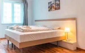 a large bed in a room with a window at Corvin holiday Apartments hotel in Budapest