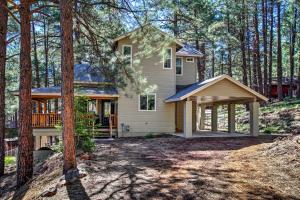 a house in the woods with a porch at Flagstaff Family Retreat with Patio and Mountain Views in Mountainaire