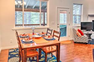 a dining room with a wooden table and chairs at Flagstaff Family Retreat with Patio and Mountain Views in Mountainaire