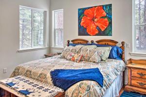 a bedroom with a bed and a painting on the wall at Flagstaff Family Retreat with Patio and Mountain Views in Mountainaire