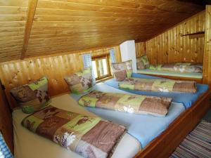 a room with three beds in a wooden cabin at Property in Hippach in Hippach