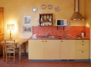 A kitchen or kitchenette at Poggio Imperiale Apartments