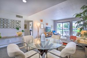a living room with a glass table and chairs at Rancho Mirage Condo on Fairway with Resort Amenities! in Rancho Mirage