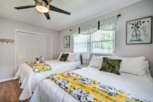a bedroom with two beds and a ceiling fan at Crystal River Getaway with Hot Tub and Game Room! in Crystal River