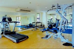 a gym with several treadmills and machines in a room at Mabolo Garden Flats 2306 in Cebu City