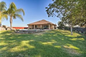 a house with a yard with palm trees at Elk Grove Getaway with Saltwater Pool Near Wineries! in Elk Grove
