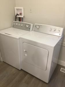 a white washer and dryer in a room at Sleeps 8! Just a 2 minute walk to Beach 1 in Wasaga Beach