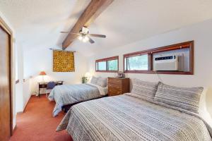 a bedroom with two beds and a ceiling fan at Whispering Pines 323 in Durango