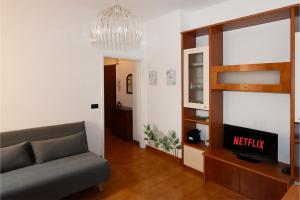 a living room with a couch and a tv at San Siro-duomo WI-FI & Netflix in Milan