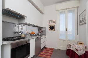 a kitchen with a stove top oven next to a window at B&B Al Parco Giardini Margherita in Bologna