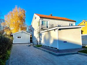 a large white building with a roll up garage at 3 rooms with private kitchen & private bathroom 5B in Gävle