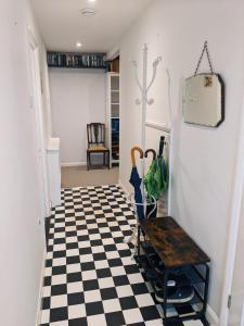 a hallway with a black and white checkered floor at Edward's Burrow in Lewes