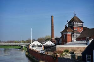 a building next to a river with a bridge at Edward's Burrow in Lewes