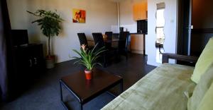 a living room with a couch and a table at Appart'hotel Les Palatines in Saint-Étienne
