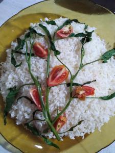 a plate of rice with tomatoes on top of it at Soma Villa, HomeStay & Restaurant in Tangalle