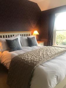 a large bed in a bedroom with a window at Number 5 in Rye