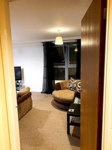 a living room with a couch and a chair at Nottingham city view apartment in Nottingham