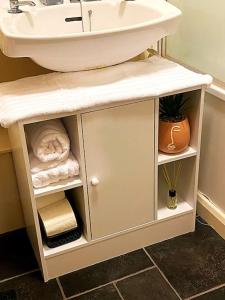 a bathroom with a sink and a counter with towels at Nottingham city view apartment in Nottingham