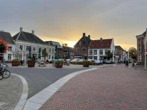 a street in a small town with houses and a street at Spacious appartement in scenic quarter with huge roof terrace in Breda