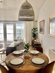 a living room with a wooden table with chairs at Relax with spectacular views and Hot Tub in Kircubbin