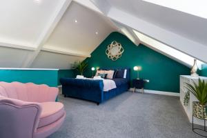 a bedroom with a blue bed and a green wall at Auckland View - a comfy & spacious 4bed with views in Coundon