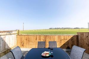 a table and chairs on a patio with a fence at Auckland View - a comfy & spacious 4bed with views in Coundon
