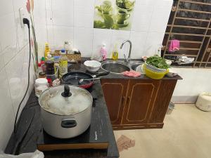 a kitchen counter with a pot on a stove at family garden 