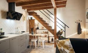 a kitchen with a staircase and a living room at La Encantada 2 in Elche de la Sierra