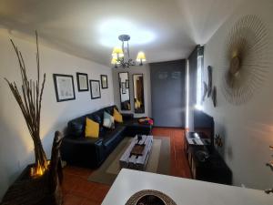 a living room with a black couch and a table at apartamento Tita in Tapia de Casariego