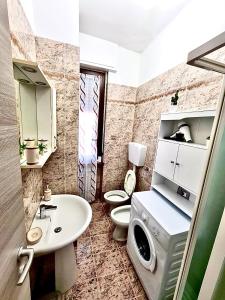 y baño con lavabo y lavadora. en Comodo Bilocale in ottima posizione, en Alessandria