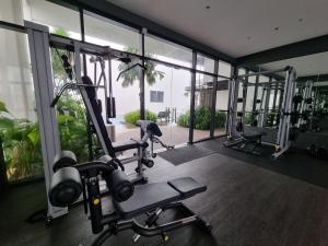 a gym with several tread machines in a room with windows at Pavilion 2 Revol Sky Pool 2-3 pax LS25 in Kuala Lumpur