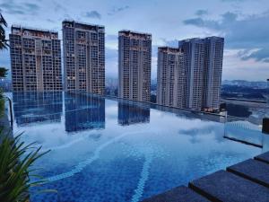 a swimming pool on top of a building with tall buildings at Pavilion 2 Revol Sky Pool 2-3 pax LS25 in Kuala Lumpur