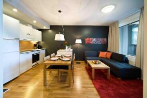 a living room with a blue couch and a table at Levi Chalets in Kittilä