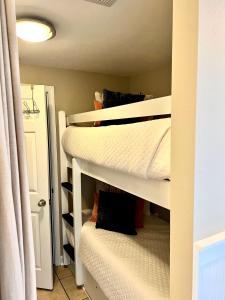 two bunk beds in a room with a closet at Cabana's @ Gulf Place #308 in Santa Rosa Beach