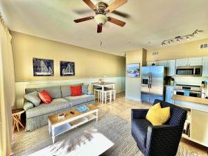 a living room with a couch and a kitchen at Cabana's @ Gulf Place #308 in Santa Rosa Beach