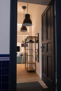 a hallway with a door and a room with a shelf at The Weinert Suites in Berlin