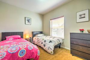 a bedroom with two beds and a dresser at Beautiful Kanab Home with Yard - Walk to Restaurants in Kanab +18 photos