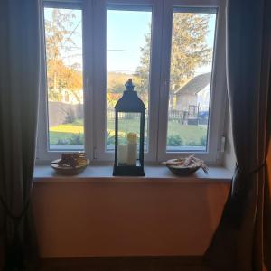 a candle in a lantern on a window sill at Het Blauwe Salamander Huis in Kékesd