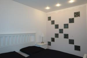 a bedroom with a bed and a wall with tiles at Lilli`s Ferienwohnung in Sinsheim